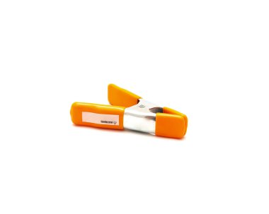 Top view spring clamp with orange poly vinyl protected handles and jaw tips contours non-slip isolated on white background, heavy duty tempered steel allows instant opening, closing. Clipping path clipart
