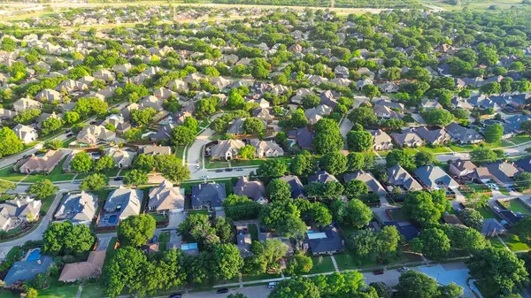 stock image Dallas suburbs and urban sprawl with row of single-family houses fenced backyard, grassy lawn in subdivision outside DFW metro complex, upscale suburban homes with swimming pool, aerial view. USA