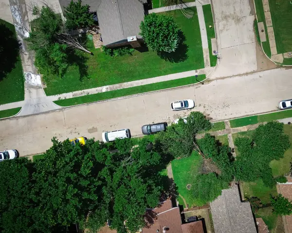 stock image Straight aerial view large broken Bradford Callery pear damages parked car on residential street, front yard curbside after severe thunderstorm, Dallas, Texas, home insurance claim, storm debris. USA