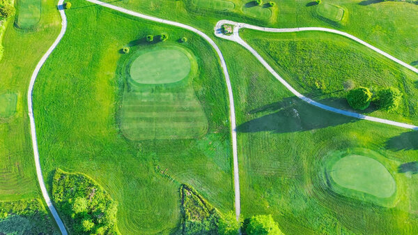 Straight aerial view cart path in 18 holes golf course, lavish greens sloping fairways, lots of trees at municipal country club in Mountain Grove, Missouri, scenic grassy lawn meadow laid back. USA
