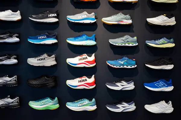 stock image SOUTHLAKE, TX, USA-JUN 12, 2024: Top brand collection of running shoes on display at upscale sport store, lightweight training, road racing, track spikes by HOKA, New Balance, Brooks, ASICS, Saucony