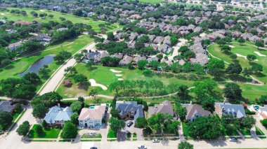 Luxury two story houses with swimming pool near golf course in East of Plano, Texas, Dallas Fort Worth metroplex, upscale large mansion homes fenced backyard, lush greenery tree, aerial view. USA clipart