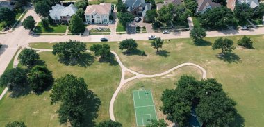 Panorama aerial view basketball courts in recreation community park of upscale neighborhood expensive two-story single-family houses with golf course in North Plano, Dallas Fort Worth Metroplex. USA clipart