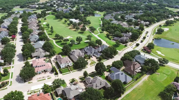 stock image Row of large mansion houses with concrete roof tiles, swimming pool, large lot in upscale golf course community residential neighborhood of North Plano, Dallas Fort Worth Metroplex, aerial view. USA