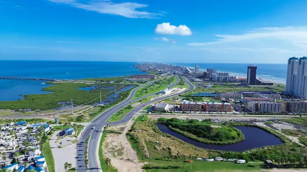 stock image Beach RV park and camping site along State Park Road 100 near downtown South Padres Island, high-rise condos, beach-front hotels, white sandy beaches turquoise water, calm waves, aerial view. USA