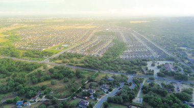 Aerial view residential area along Louis Agusta Drive in West of San Antonio, Texas, row of new development two-story single-family homes with cul-de-sac keyhole shape dead-end street, greenery. USA clipart