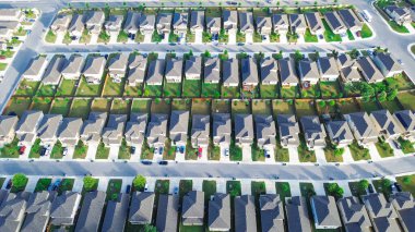 Row of new construction homes share same backyard fence boundary line between two properties suburban neighborhood in West of San Antonio, Texas, long narrow lot single family house subdivision. USA clipart