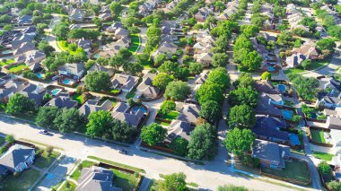 Peaceful residential street in Riverbend North neighborhood row of upscale suburban houses with swimming pools in West Plano, urban sprawl suburbs Dallas Fort Worth metroplex, Texas, aerial view. USA clipart