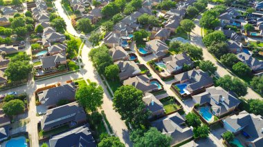 Tree lined residential street in upscale suburban Wentworth Estates neighborhood in West Plano, Texas, two-story single-family homes, swimming pool, suburbs Dallas Fort Worth metroplex, aerial. USA clipart