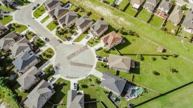 Cul-de-sac dead-end keyhole shape street in new development community outside San Antonio, TX, row of two-story suburban houses with large grassy backyard, urban sprawl in New Braunfels, aerial. USA clipart