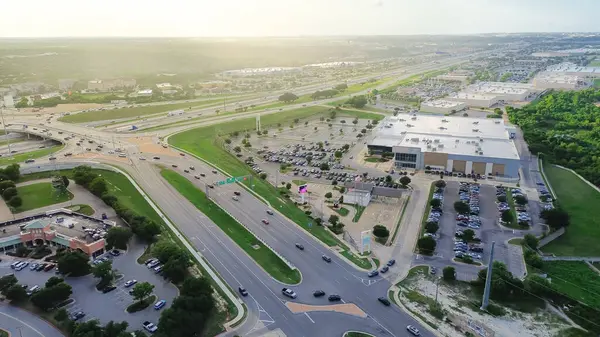 stock image Highway intersection with overpass between interstate I-35, Monarch Hwy and West Parmer Lane in North Austin, busy traffic at peak hour, large suburban shopping center, apartment complex, aerial. USA