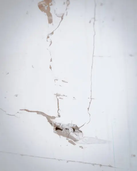 stock image Measurement and marking line on broken drywall boards flat panel made from gypsum plaster and thick paper at garage of residential house in Dallas, Texas, surface defects need patch, repair DIY. USA