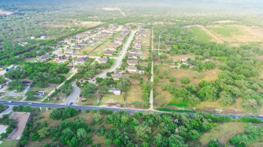 New development neighborhood with vacant available land for additional construction grow in West of San Antonio, TX, upscale two-story houses extra-large backyard and fiberglass pools, aerial. USA clipart