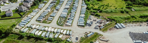 Panorama aerial new construction suburban residential neighborhood row two-story houses near prefab fiberglass swimming pool manufacturer factory yard, New Braunfels, suburbs San Antonio, Texas. USA