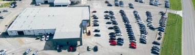 Panorama aerial view car dealership wide variety of auto brands at outdoor parking lot near Interstate highway I-35 New Braunfels, suburbs San Antonio, Texas, new and used gas vehicles for sale. USA clipart