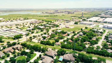 Suburban Dallas Fort Worth metropolitan area with light rail system, mixed industrial and residential zone, warehouse distribution center, lakeside apartment complex along Belt Line Road, aerial. USA clipart