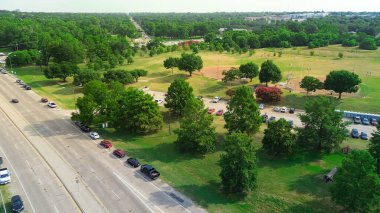 Norbuck Park 'ta spor karşılaşması için kalabalık arabalı portatif tuvalet Old Lake Highlands mahallesi yakınlarındaki halk beyzbol sahaları çimenli çimler, LED lambalar, White Rock Dallas, anten. ABD
