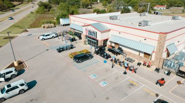 BARTONVILLE, TX, US-OCT 31, 2024: Farm to Market Road 407 in front of Tractor Supply store, an American chain sells home improvement, agriculture, lawn garden maintenance, livestock, pet care supplies clipart