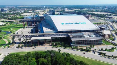 ARLINGTON, TX, US-AUG 8, 2024: Aerial view Globe Life Field retractable roof stadium along Cowboys Way with downtown building skylines background, home ballpark of Major League Baseball Texas Rangers clipart