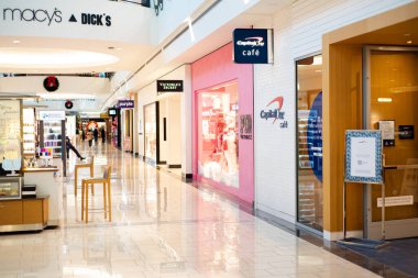 FRISCO, TX, US-NOV 19, 2024: Fashion brand near Capital One Caf with sandwich board signs LED, bank-affiliated coffeehouse chain inside urban shopping mall offering hot drinks Vertue Coffee Roasters clipart