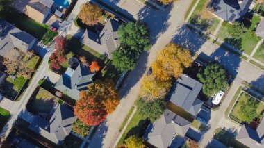 Suburban houses backyard with trampoline, swimming pool, colorful fall foliage leaves in upscale residential area, Coppell, suburbs Dallas Fort Worth metroplex, fast growing housing market, aerial. US clipart