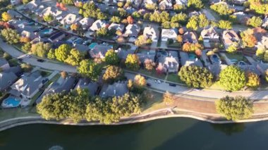 Coppell, Dallas County, Teksas 'taki lüks banliyö yerleşim yerleri, renkli sonbahar yaprakları, küme halinde iki katlı yüzme havuzları, büyük arka bahçe, güneş paneli çatısı, üstgeçit.