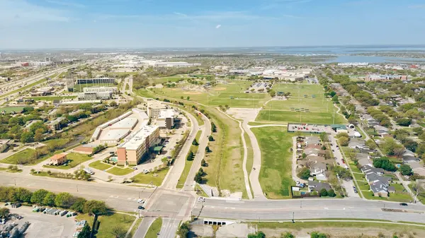 Texas Karayolu 121 hızla büyüyen Dallas Koloni banliyöleri, ticari binalar, otel, beyzbol parkı, konut evleri, arka planda Lewisville Gölü, anten. ABD