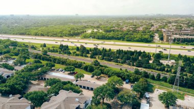 Otoyol kenarındaki apartman kompleksi. Başkan George Bush 'un Dallas' taki otoyolu boyunca kapalı otoparkı var. Yeşilci planlama topluluğu, kiralık birimler, konutlar. ABD
