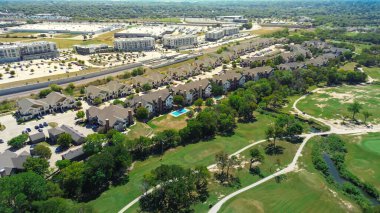 Creek and greenbelt at Iron Horse Golf Course in North Richland Hills near master planned community with light industrial warehouses, office building, townhomes, multifamily, apartment complexes. USA