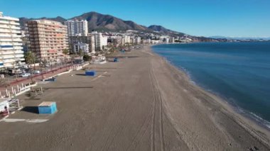 Fuengirola, Andalusia, Spain. Clear beach with mountains in background.