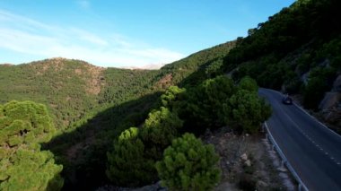 Aerial view from above road with mountains, green trees. Parque Nacional Sierra de las Nieves