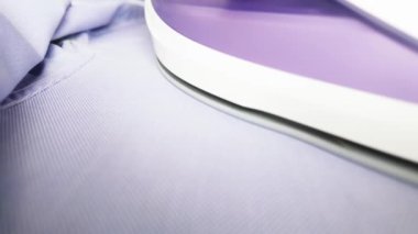 Üst düzey biri evde mavi tişört ütülüyor. Ev işleri konsepti yapıyorum. Yüksek kalite 4k görüntü