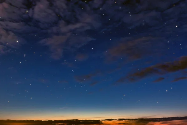 evening sky, day turns to night. Sunset, clouds and starry sky. A wonderful natural background.