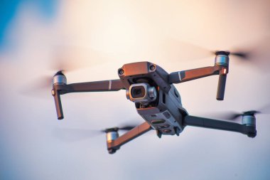 Quadcopter with a high-quality camera on the background of the sky