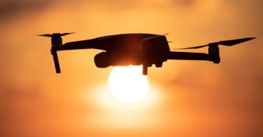 Quadcopter with a high-quality camera on the background of the sky