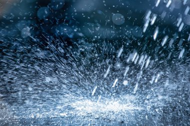 Raindrops fall on the asphalt. Deterioration of weather conditions. Precipitation, cooling.