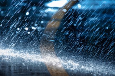 Raindrops fall on the asphalt. Deterioration of weather conditions. Precipitation, cooling.