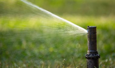 Automatic lawn watering system, watering the lawn in the backyard.