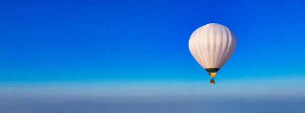 White balloon on the background of the blue sky panorama. Drone view.