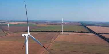 Wind turbines on flat terrain. Panorama. Green energy. Use of renewable sources of electricity. Zero emissions.