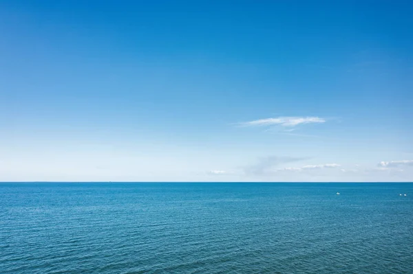 Horizon line, blue sky and blue sea. Drone view. Abstract natural background.