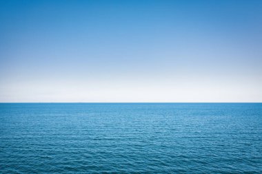 Horizon line, blue sky and blue sea. Drone view. Abstract natural background.