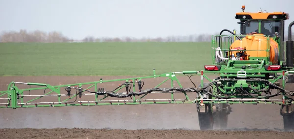 Soil treatment with drugs. Application of herbicides. pesticides or fertilizers with the help of a tractor.
