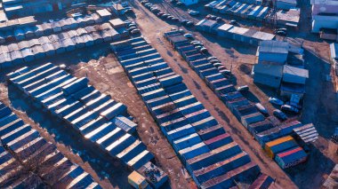 Roofs of old garages drone view. Rusty metal roof. Abandoned garage cooperative.