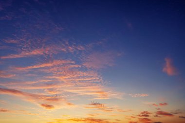 The sky before dawn, orange clouds on the background of the blue sky. Abstract natural background.