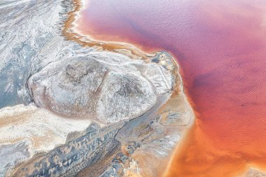 vast titanium mine with tailing ponds filled with technical fluids used in the process of ore enrichment.