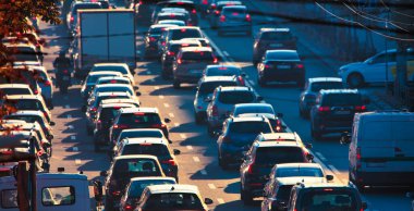 This photograph encapsulates the hustle and bustle of the morning commute, as drivers fight for a spot on the congested city streets
