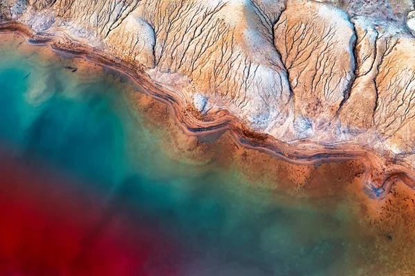 vast titanium mine with tailing ponds filled with technical fluids used in the process of ore enrichment.