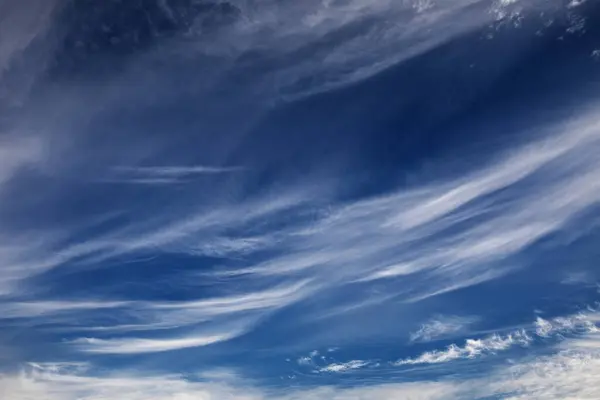 Nature\'s Symphony: Fluffy Clouds Amidst Post-Storm Sky and Earth