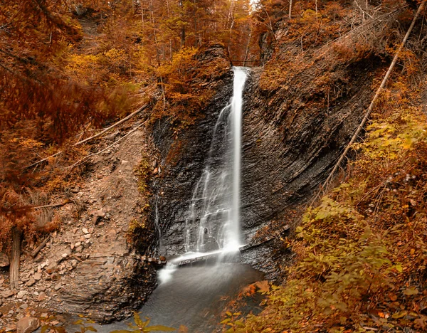 Mountainside Veil: Aerial View of Autumn\'s Waterfall Symphony